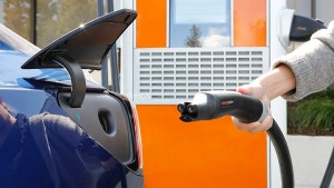 Customer using an NACS charger at a ChargePoint station